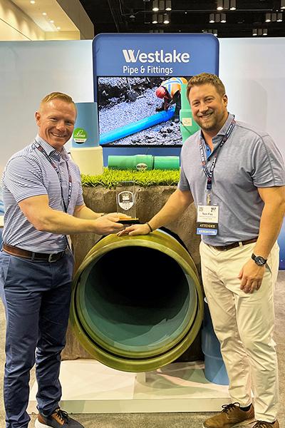 Booth display with Jay Cooper and Tom Fox, Municipal Sales